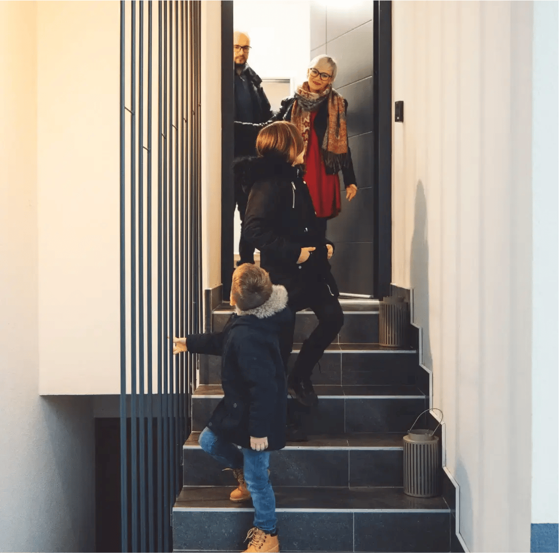 Family-ascending-a-staircase-in-their-new-modern