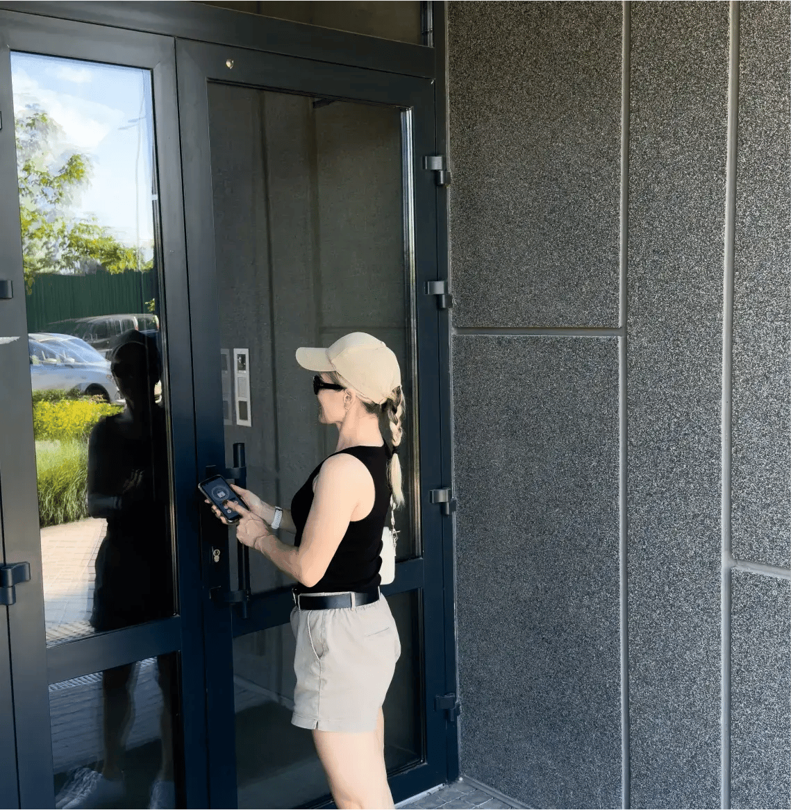 Woman-uses-smartphone-to-open-the-door-of-his-house
